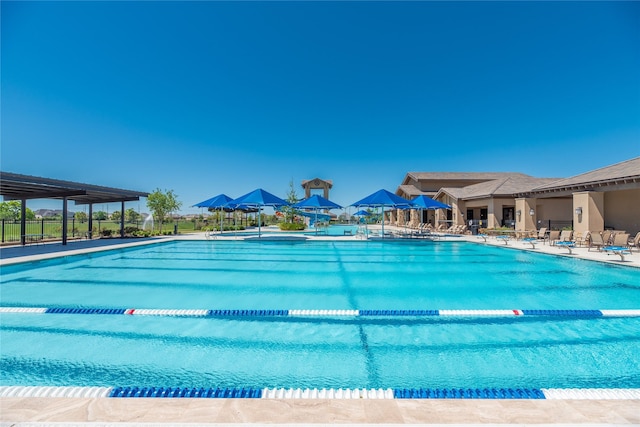 community pool featuring a patio and fence