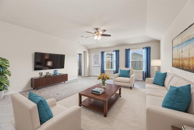 living area featuring lofted ceiling, ceiling fan, light colored carpet, visible vents, and baseboards