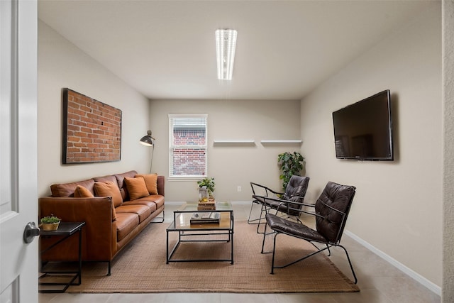 living area featuring baseboards