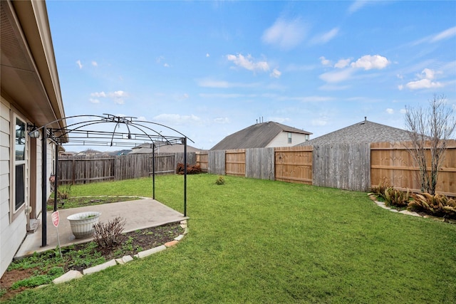 view of yard with a patio area and a fenced backyard