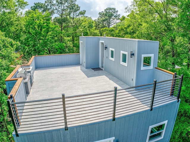 view of property exterior with a wooden deck