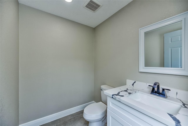 half bath featuring toilet, baseboards, visible vents, and vanity