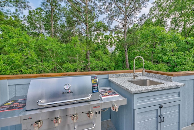 view of patio featuring a grill and a sink