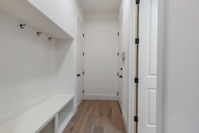 mudroom with baseboards and light wood finished floors