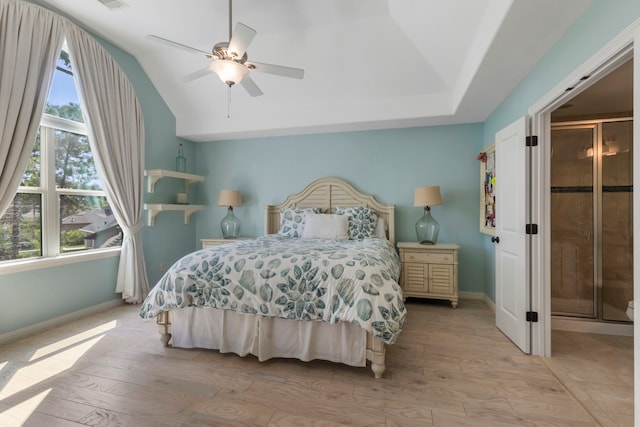 bedroom with lofted ceiling, visible vents, a ceiling fan, baseboards, and light wood finished floors