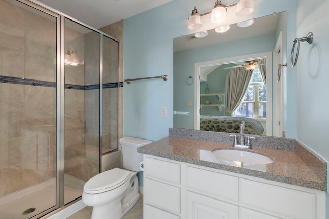 ensuite bathroom featuring connected bathroom, toilet, ceiling fan, vanity, and a shower stall