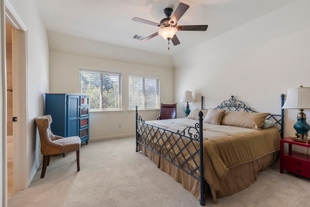 bedroom with lofted ceiling, light colored carpet, a ceiling fan, baseboards, and visible vents