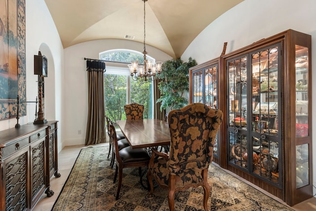 dining room with arched walkways, visible vents, vaulted ceiling, and a notable chandelier