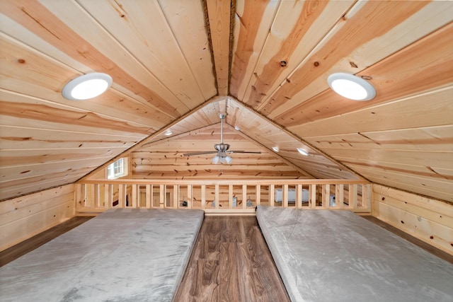 bonus room featuring vaulted ceiling, dark wood-type flooring, wood ceiling, and wooden walls