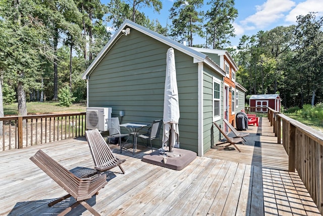 334 County Road 3190, Colmesneil, TX 75938 - wooden deck featuring a storage unit, outdoor dining space, and view of scattered trees