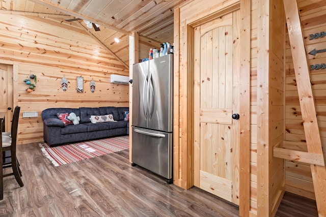 334 County Road 3190, Colmesneil, TX 75938 - kitchen featuring freestanding refrigerator, wooden ceiling, wood walls, wood finished floors, and lofted ceiling