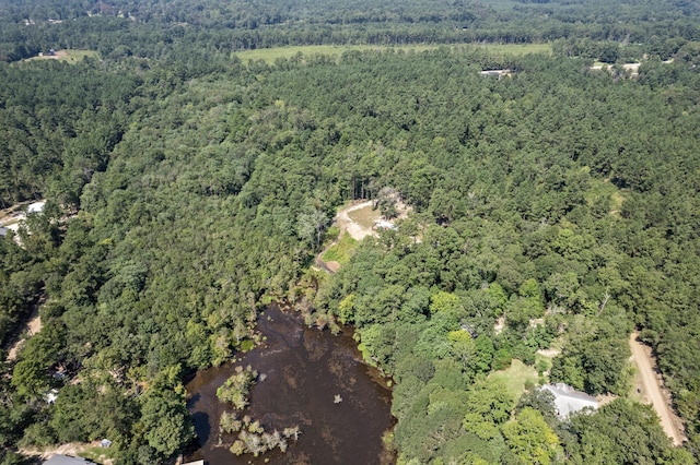 birds eye view of property with a view of trees