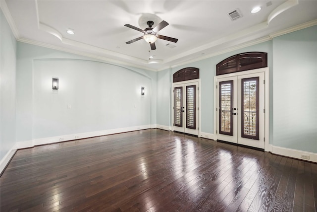 empty room with french doors, a raised ceiling, wood-type flooring, visible vents, and baseboards