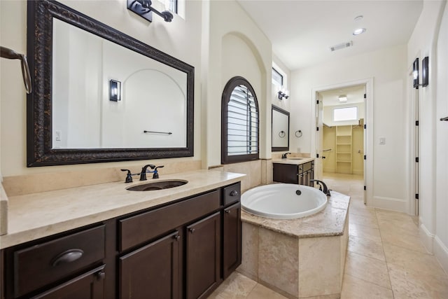 full bath with tile patterned floors, visible vents, a sink, and a bath