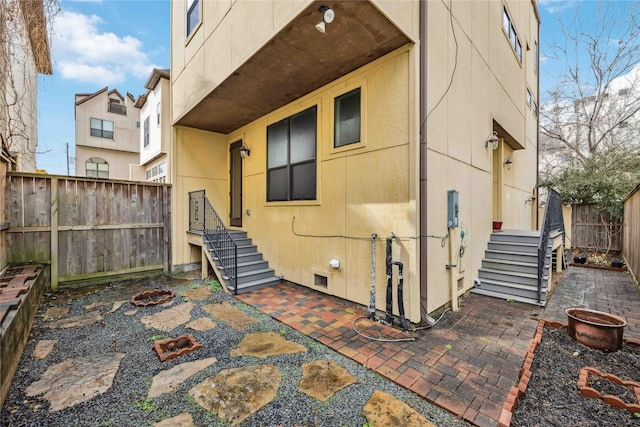 back of house featuring a patio area and a fenced backyard