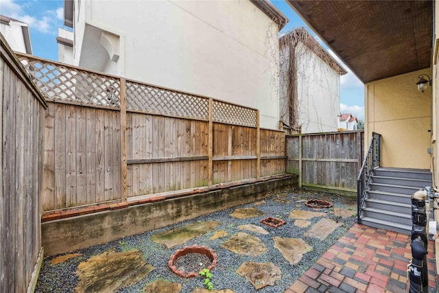 view of patio / terrace featuring a fenced backyard and a fire pit