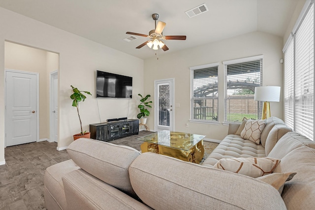 living area featuring lofted ceiling, visible vents, ceiling fan, and baseboards