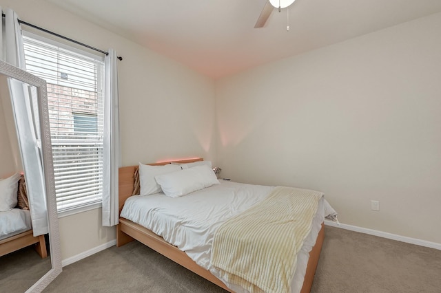 bedroom featuring light colored carpet, ceiling fan, and baseboards