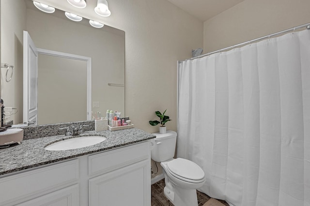 full bath featuring vanity and toilet