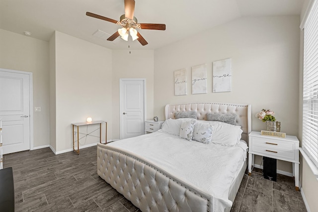 bedroom with dark wood-style floors, lofted ceiling, ceiling fan, and baseboards