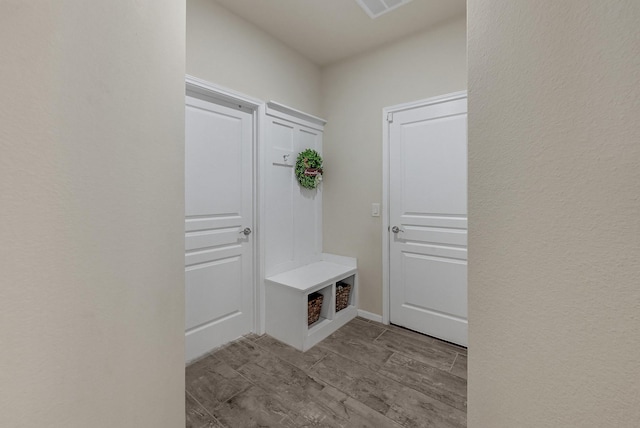 mudroom with wood tiled floor