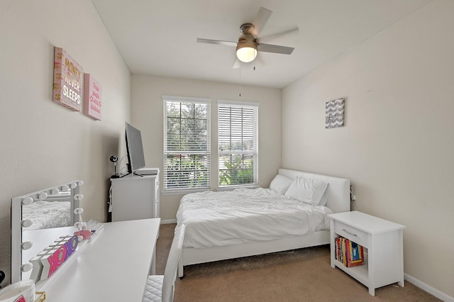 carpeted bedroom featuring ceiling fan and baseboards