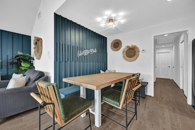 dining space featuring visible vents, wood finished floors, and attic access