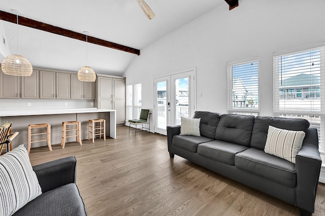 living area with light wood finished floors, high vaulted ceiling, beam ceiling, and french doors