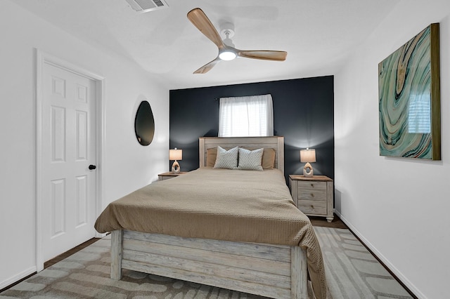 bedroom featuring baseboards, visible vents, and a ceiling fan