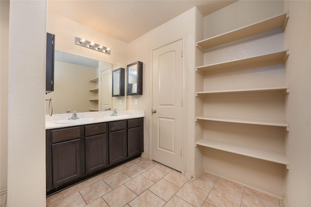 bathroom featuring tile patterned flooring, a sink, and double vanity