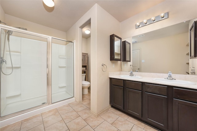 full bathroom with double vanity, a shower stall, and a sink