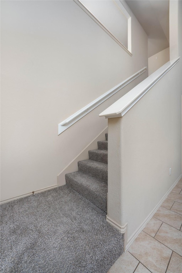 stairway with tile patterned floors