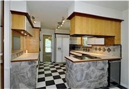 kitchen featuring tasteful backsplash, light countertops, and tile patterned floors