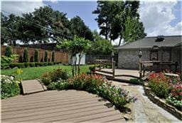 exterior space with fence, a deck, and an outdoor structure