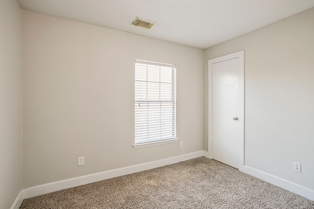 empty room with light carpet, baseboards, and visible vents