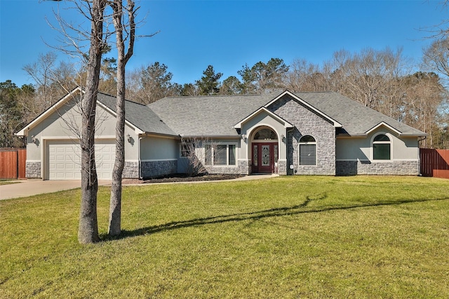 view of front of house with stucco siding, fence, a garage, stone siding, and a front lawn