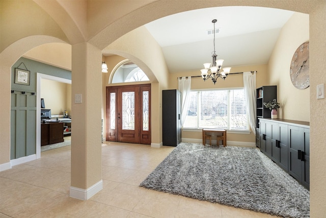 foyer entrance featuring lofted ceiling, light tile patterned floors, a chandelier, visible vents, and baseboards