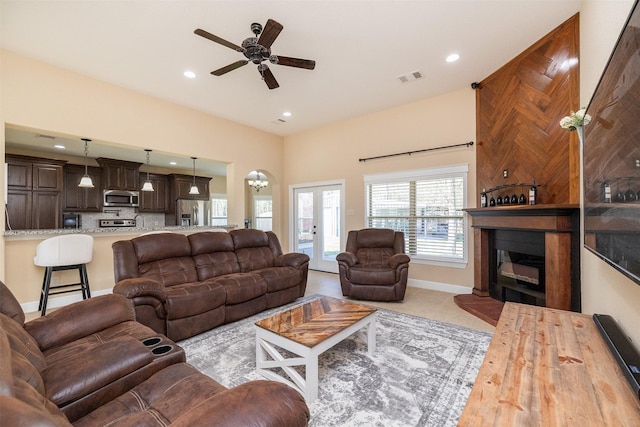 living area with french doors, recessed lighting, visible vents, a glass covered fireplace, and ceiling fan