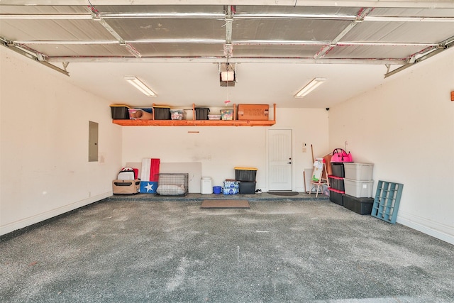 garage with baseboards, electric panel, and a garage door opener