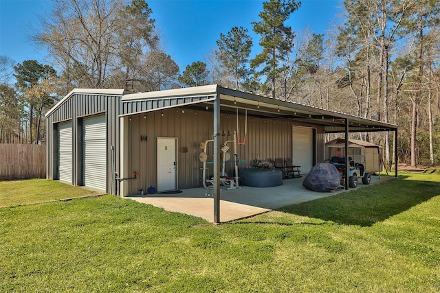 exterior space with a detached garage and fence