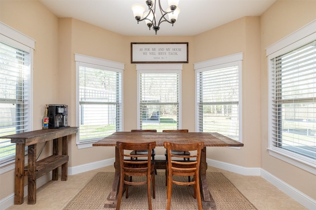 dining area with light tile patterned floors, baseboards, and a chandelier