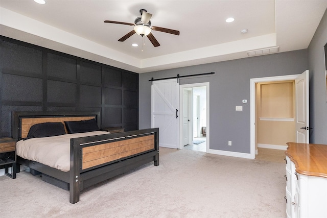 bedroom with recessed lighting, light colored carpet, visible vents, and a barn door