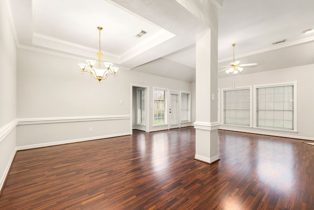 unfurnished living room with dark wood-style floors, a tray ceiling, visible vents, and baseboards