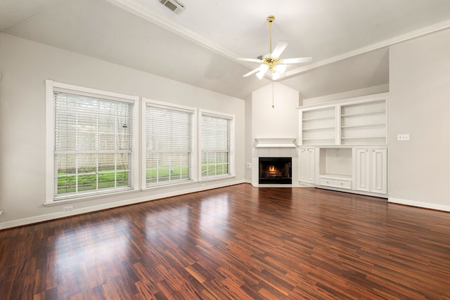 unfurnished living room with lofted ceiling, visible vents, dark wood-style flooring, and a tile fireplace