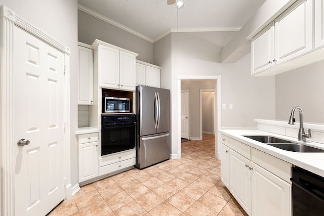 kitchen featuring stainless steel appliances, light countertops, ornamental molding, white cabinets, and a sink