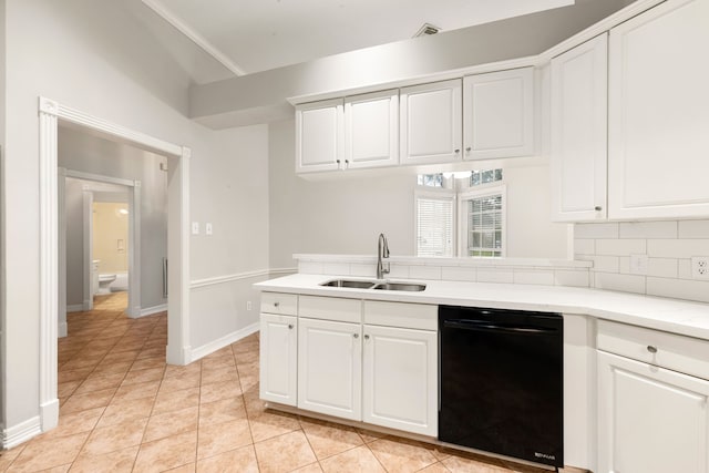 kitchen featuring dishwasher, light countertops, a sink, and white cabinetry