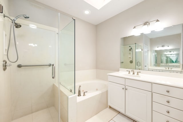 full bath with a stall shower, a skylight, a tub with jets, tile patterned flooring, and vanity