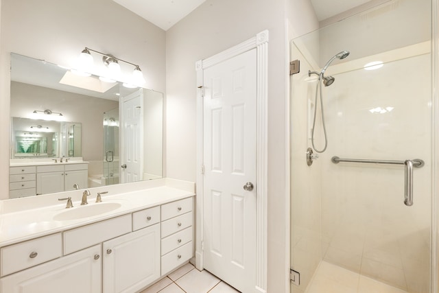 bathroom with a shower stall, vanity, and tile patterned floors