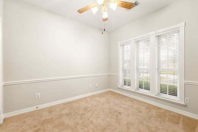 empty room featuring baseboards, a ceiling fan, and carpet flooring