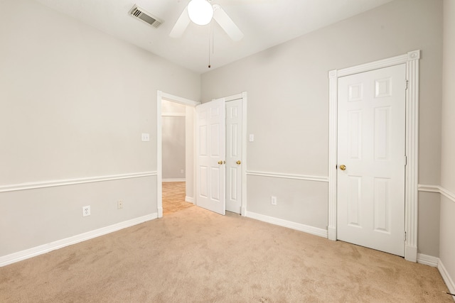 unfurnished bedroom with carpet, visible vents, ceiling fan, and baseboards